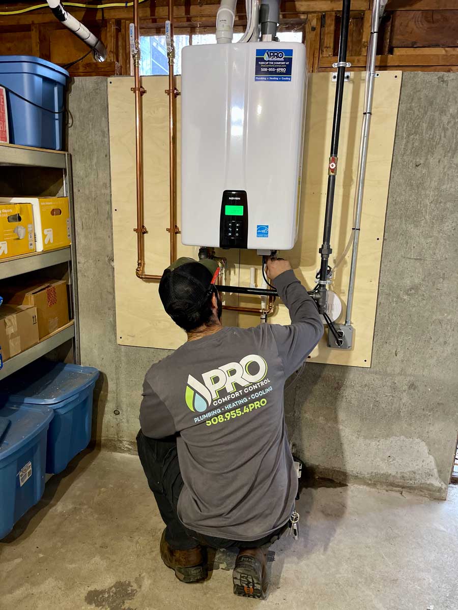 Technician testing a water heater that keeps tripping in a Franklin, MA home